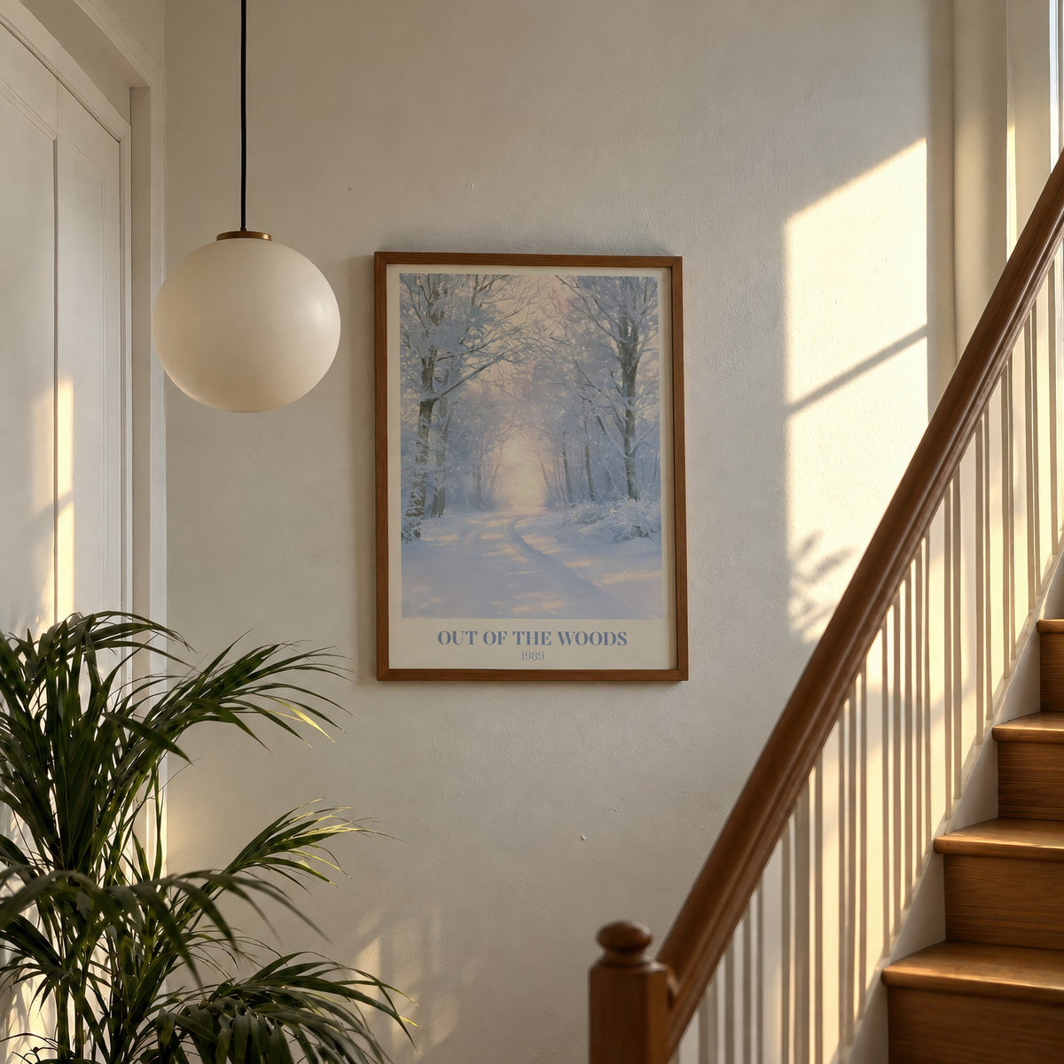 Out Of The Woods Winter Taylor Swift print of a snowy woodland path, hung on a sunlit stair landing