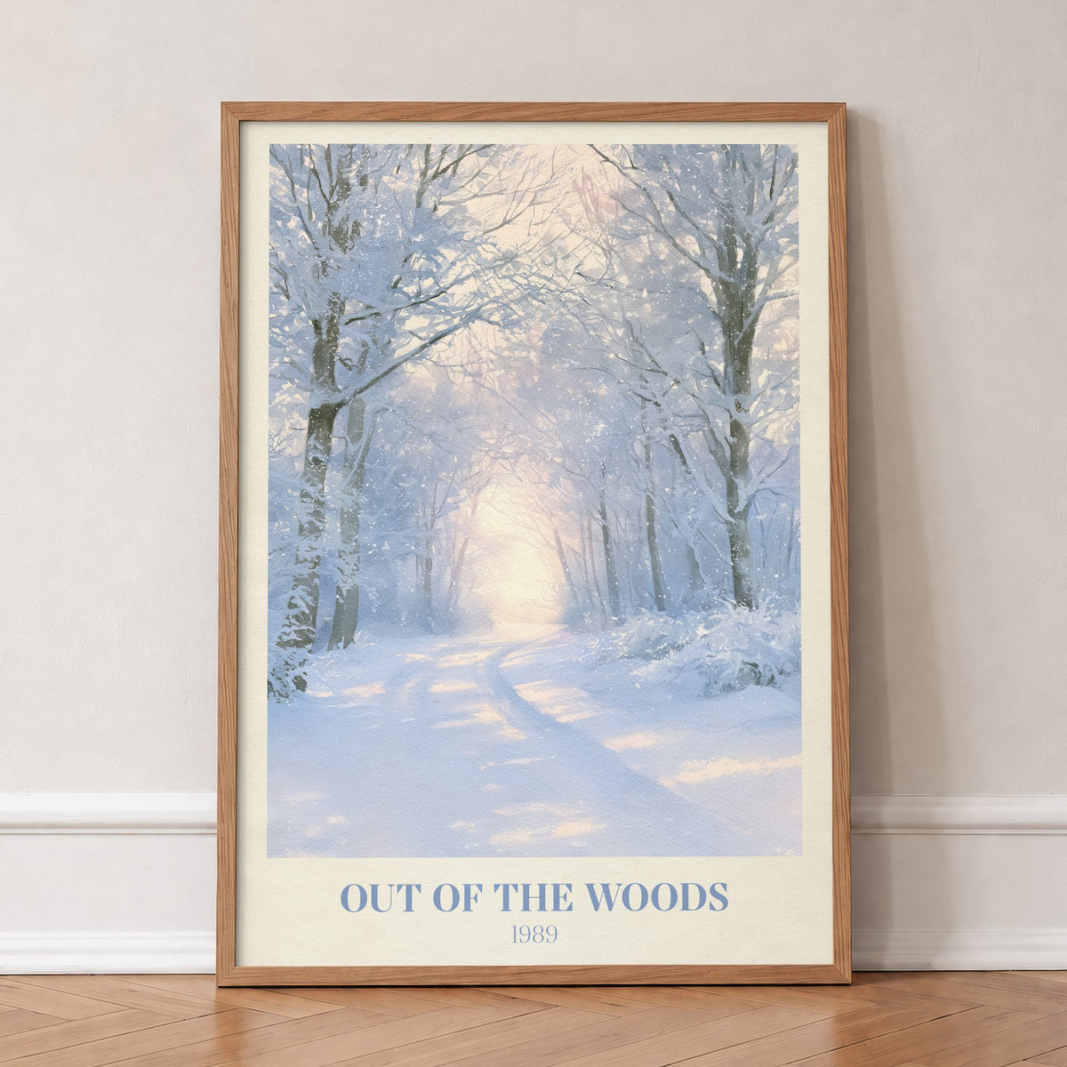 Out Of The Woods Winter Taylor Swift print of a snowy woodland path, in an oak frame, leaning against a wall on a herringbone floor