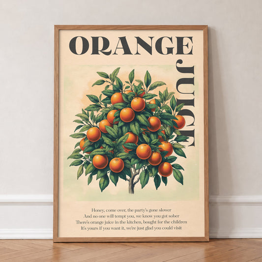 Orange Juice Noah Kahan lyric print of a vintage orange tree under bold lettering, in an oak frame, leaning against a wall on a herringbone floor