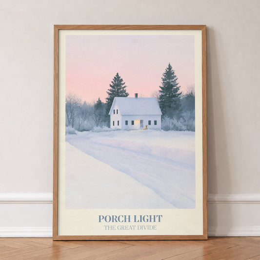 Porch Light Noah Kahan print of a snowy farmhouse, porch light on, in an oak frame, leaning against a wall on a herringbone floor