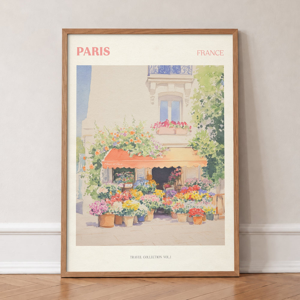 Paris travel print of a flower stall with an orange awning and pots of bright flowers, in an oak frame, leaning against a wall on a herringbone floor