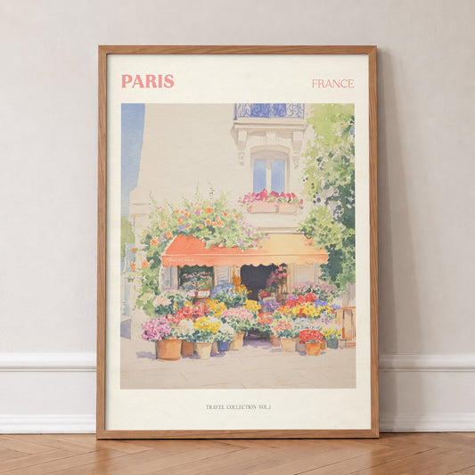 Paris travel print of a flower stall with an orange awning and pots of bright flowers, in an oak frame, leaning against a wall on a herringbone floor