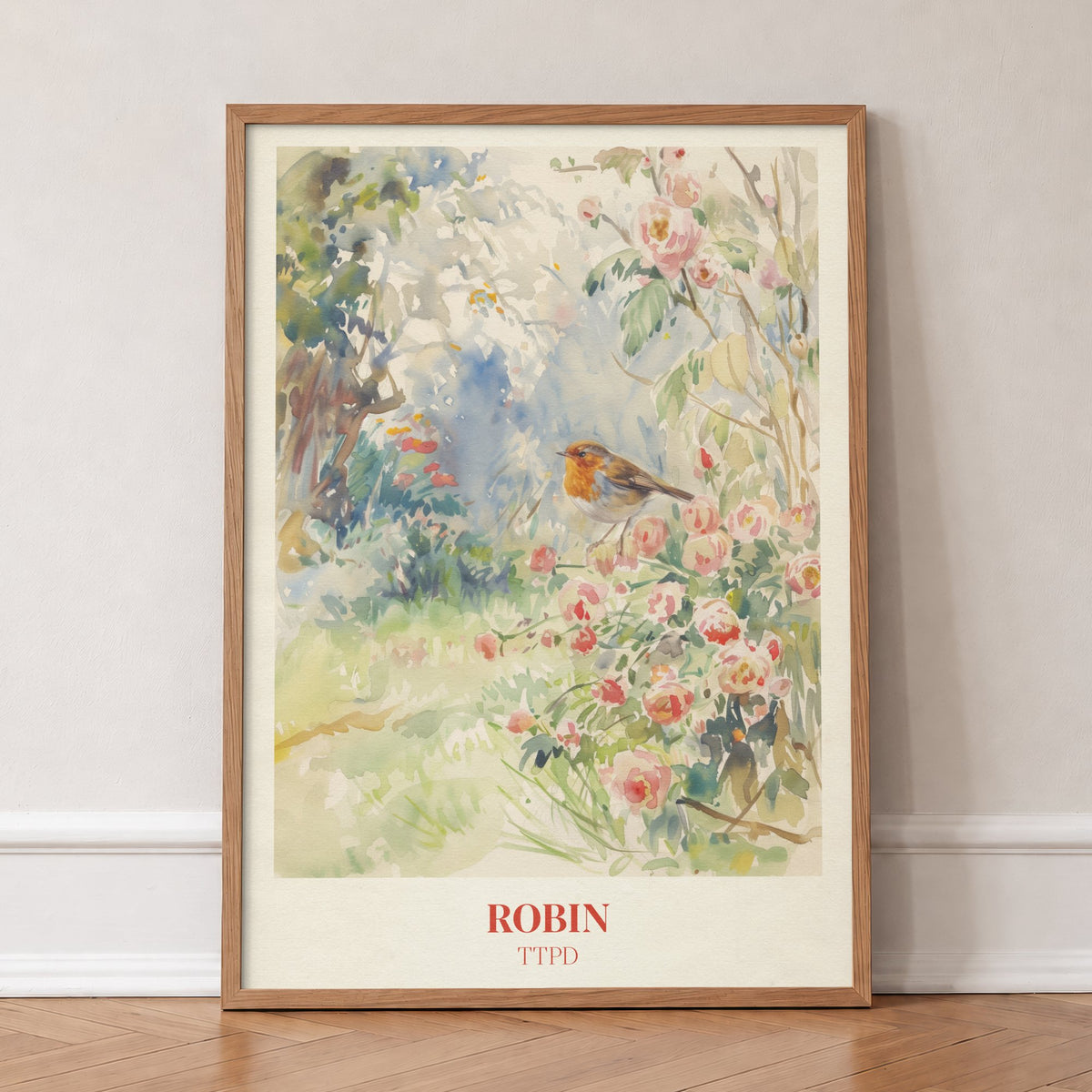 Robin Taylor Swift print of a robin among pink wild roses in a garden, in an oak frame, leaning against a wall on a herringbone floor