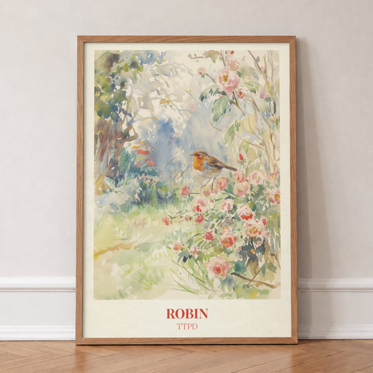Robin Taylor Swift print of a robin among pink wild roses in a garden, in an oak frame, leaning against a wall on a herringbone floor