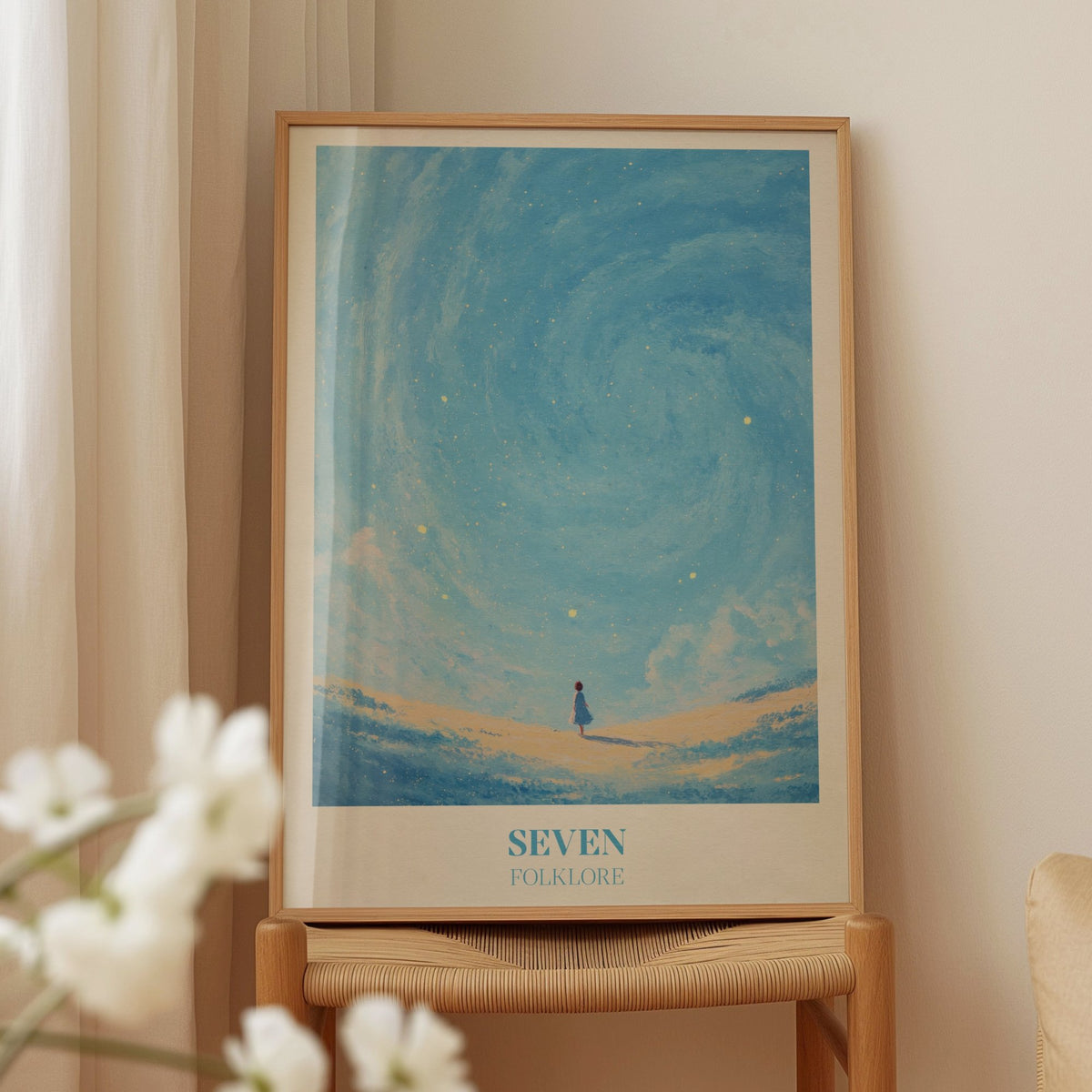 Seven Taylor Swift print of a little girl in a blue dress under a swirling, starry blue sky, framed on a wooden chair