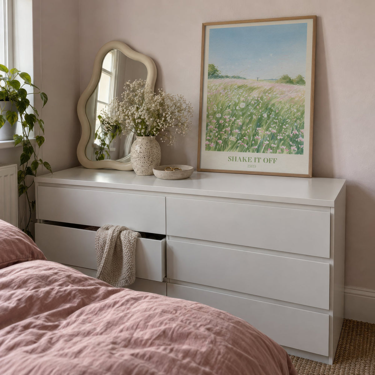 Shake It Off Taylor Swift print of a pink wildflower meadow, leaning on a white dresser beside a wavy mirror
