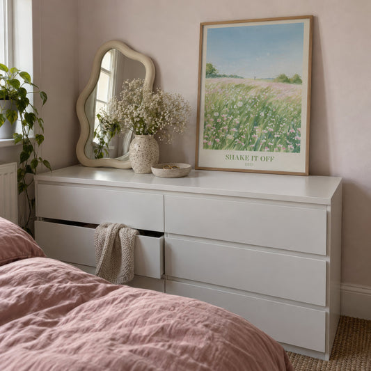Shake It Off Taylor Swift print of a pink wildflower meadow, leaning on a white dresser beside a wavy mirror