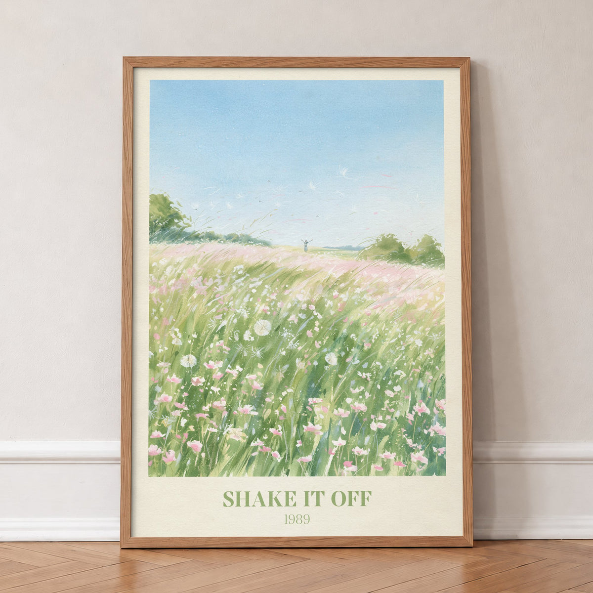 Shake It Off Taylor Swift print of a pink wildflower meadow, in an oak frame, leaning against a wall on a herringbone floor