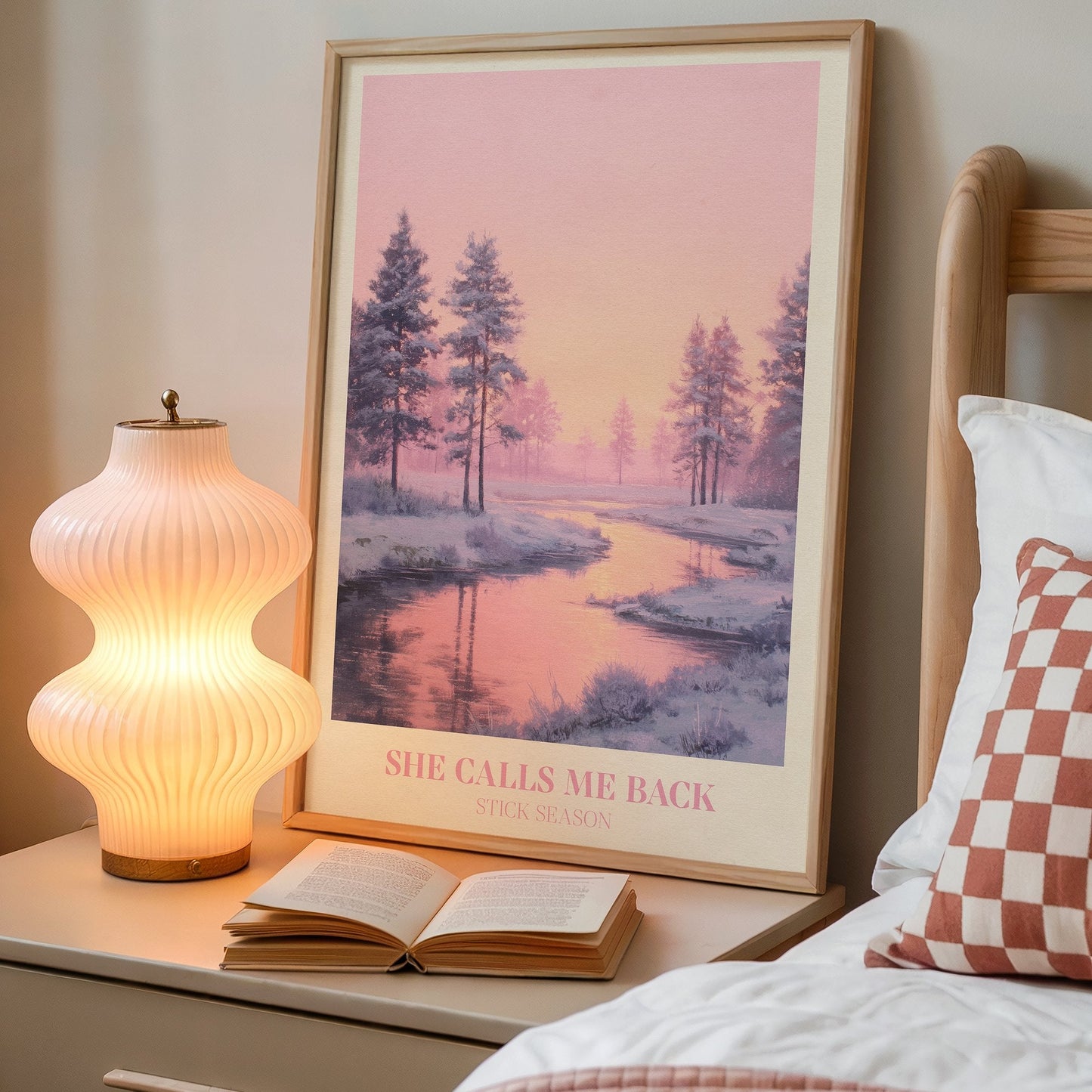 She Calls Me Back lyric wall art print inspired by Noah Kahan on a bedside table next to a lamp