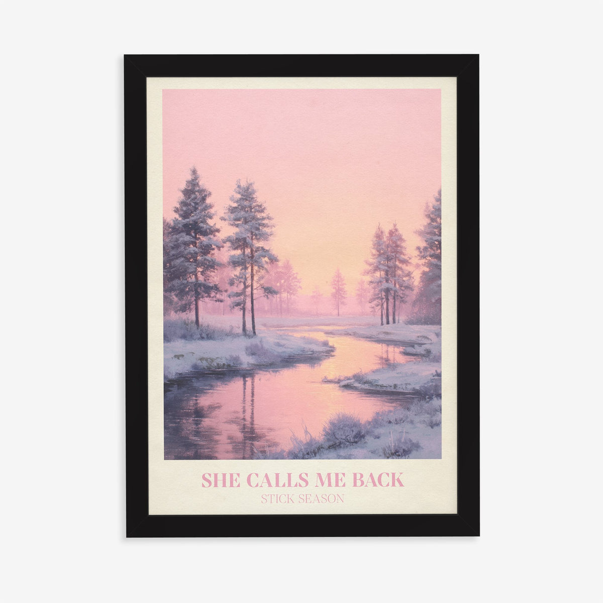 She Calls Me Back Noah Kahan print of a frosty river winding between pines under a pink sky, in a black frame on a plain wall
