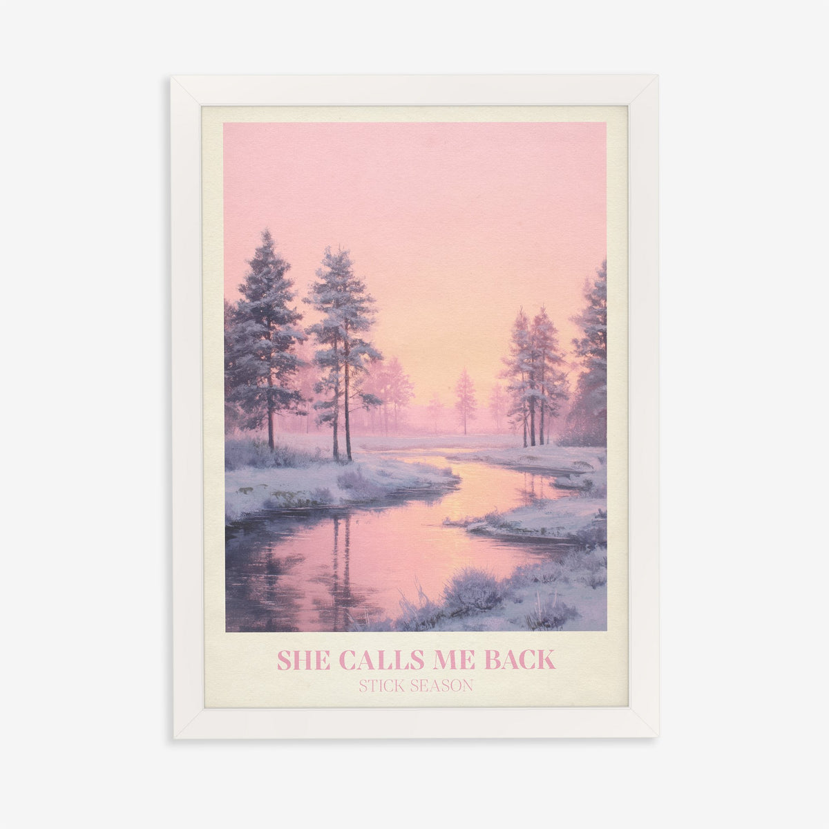 She Calls Me Back Noah Kahan print of a frosty river winding between pines under a pink sky, in a white frame on a plain wall