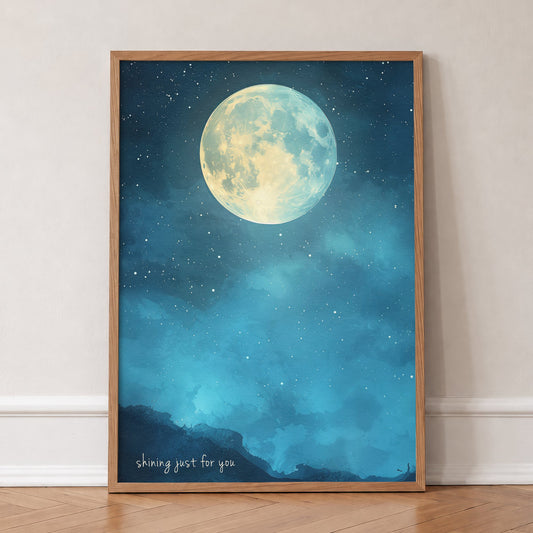 Shining Just For You Taylor Swift print of a full moon over a starry blue night sky, in an oak frame, leaning against a wall on a herringbone floor
