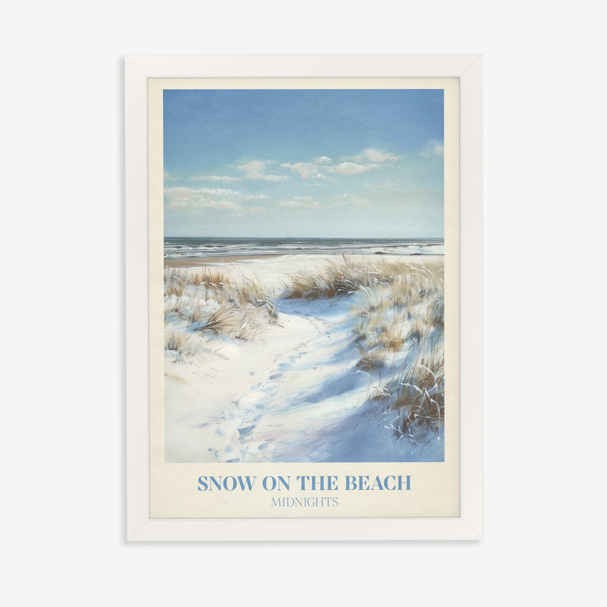 Snow On The Beach Taylor Swift print of snowy sand dunes and beach grass beside a blue sea, in a white frame on a plain wall