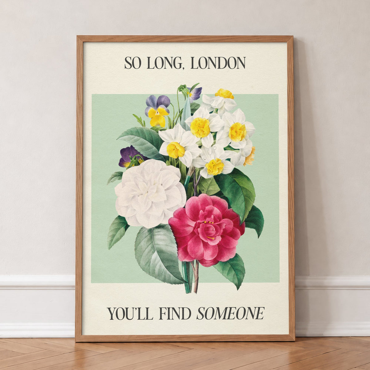So Long London Botanical Taylor Swift print of camellias, narcissi and pansies on mint green, in an oak frame, leaning against a wall on a herringbone floor