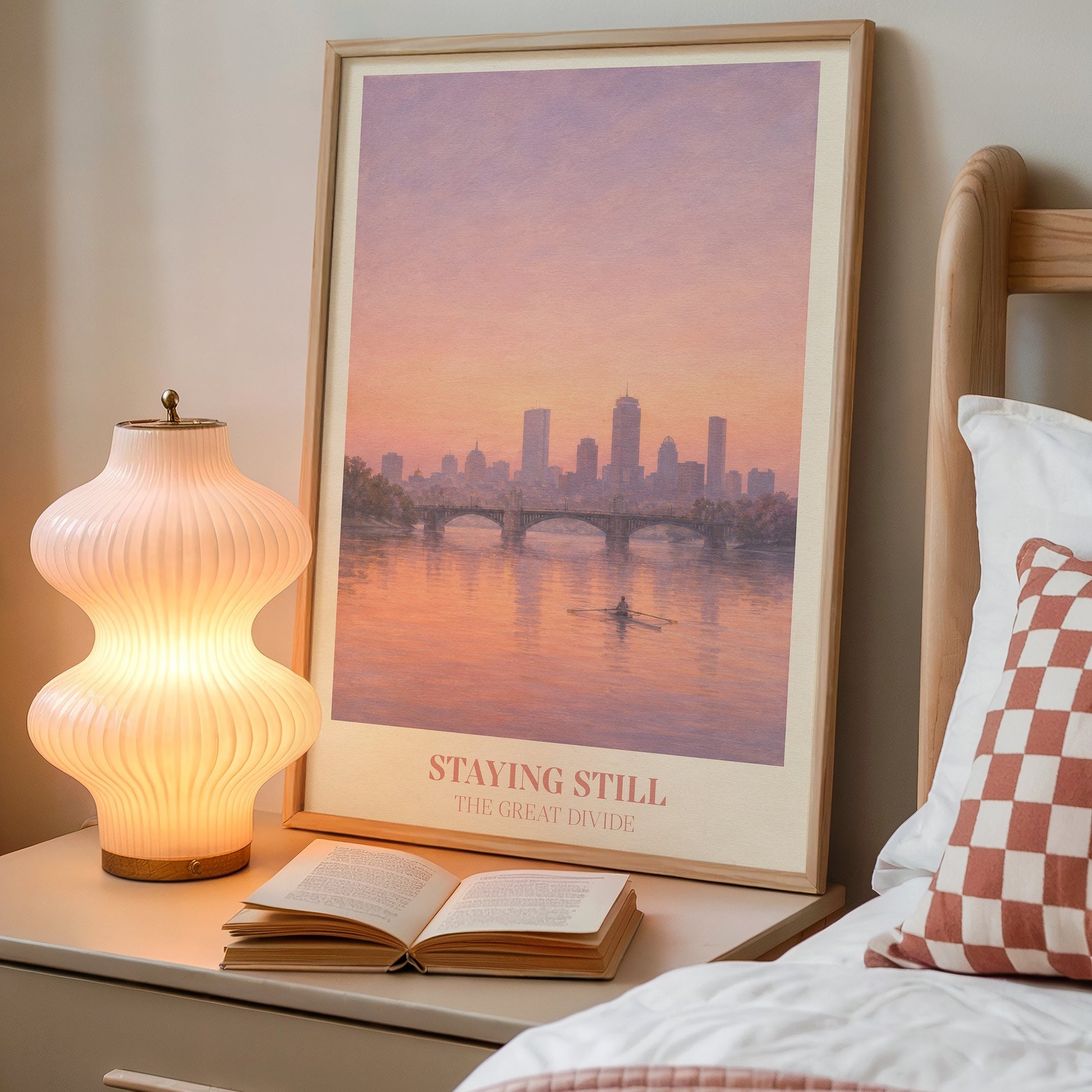 Staying Still lyric wall art print inspired by Noah Kahan on a bedside table next to a lamp