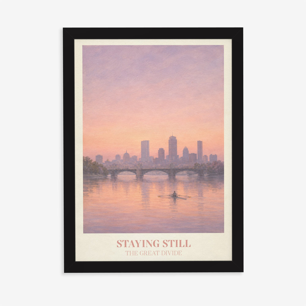 Staying Still Noah Kahan print of a lone rower on a pink river below a city skyline, in a black frame on a plain wall
