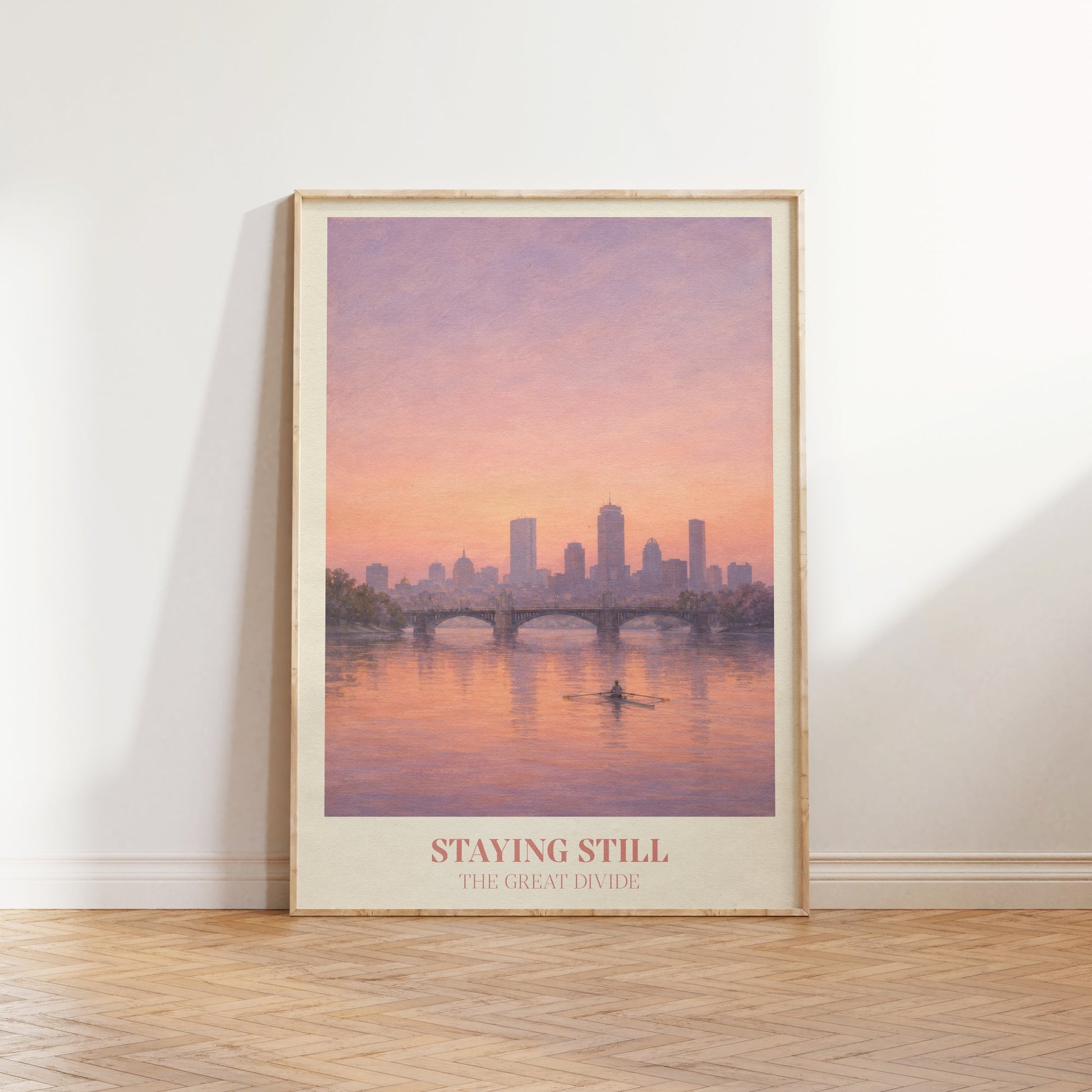 Staying Still lyric wall art print inspired by Noah Kahan leaning against a white wall on a wooden herringbone floor in soft daylight