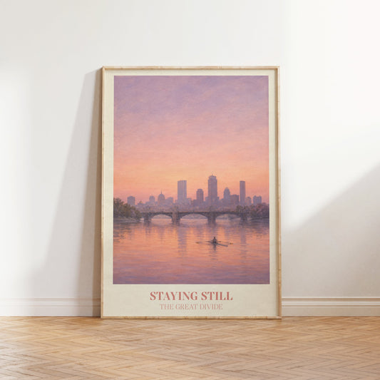 Staying Still lyric wall art print inspired by Noah Kahan leaning against a white wall on a wooden herringbone floor in soft daylight