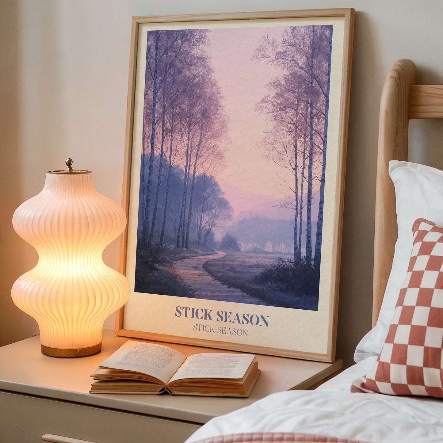 Stick Season lyric wall art print inspired by Noah Kahan on a bedside table next to a lamp