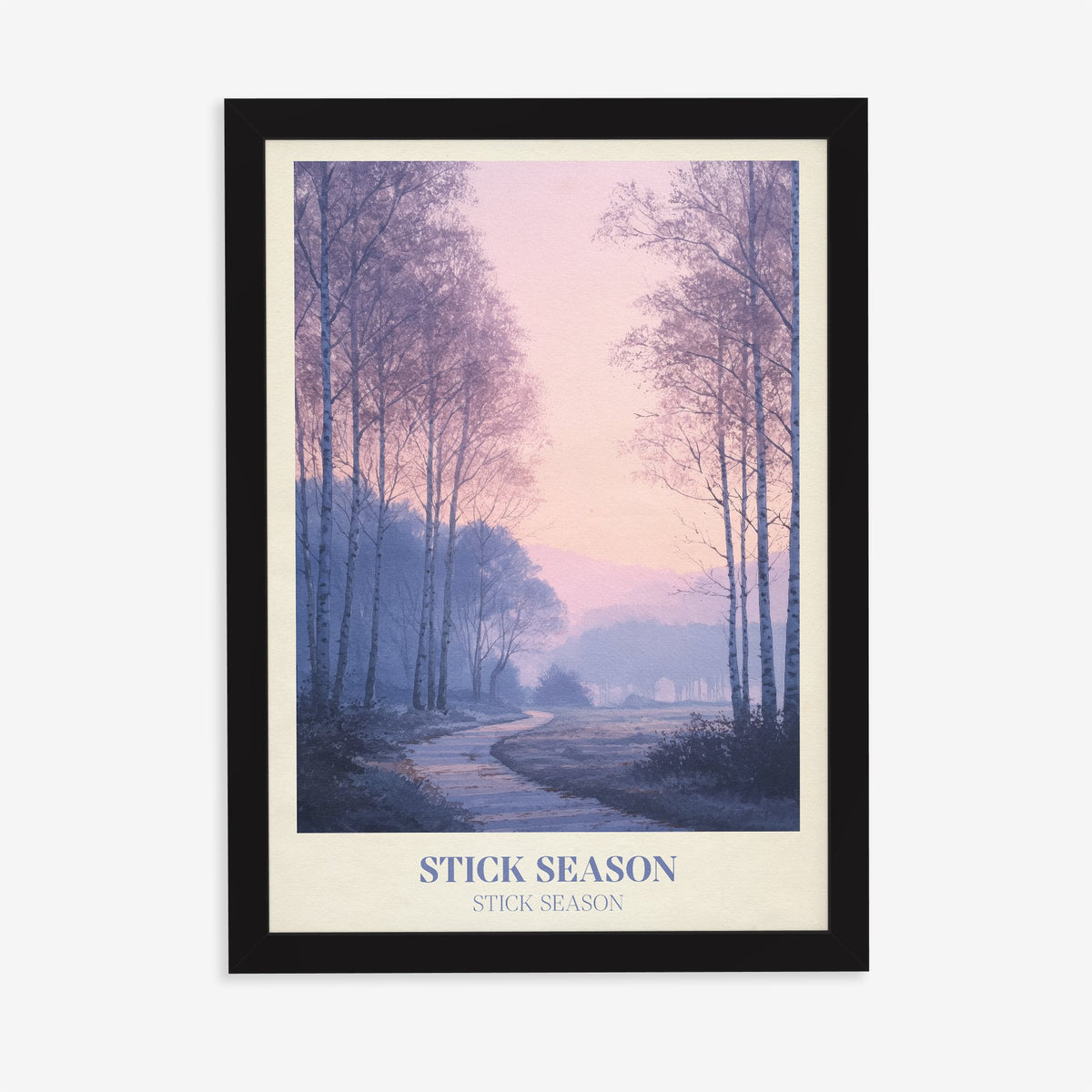 Stick Season Noah Kahan print of a misty path through bare birch trees under a pink sky, in a black frame on a plain wall