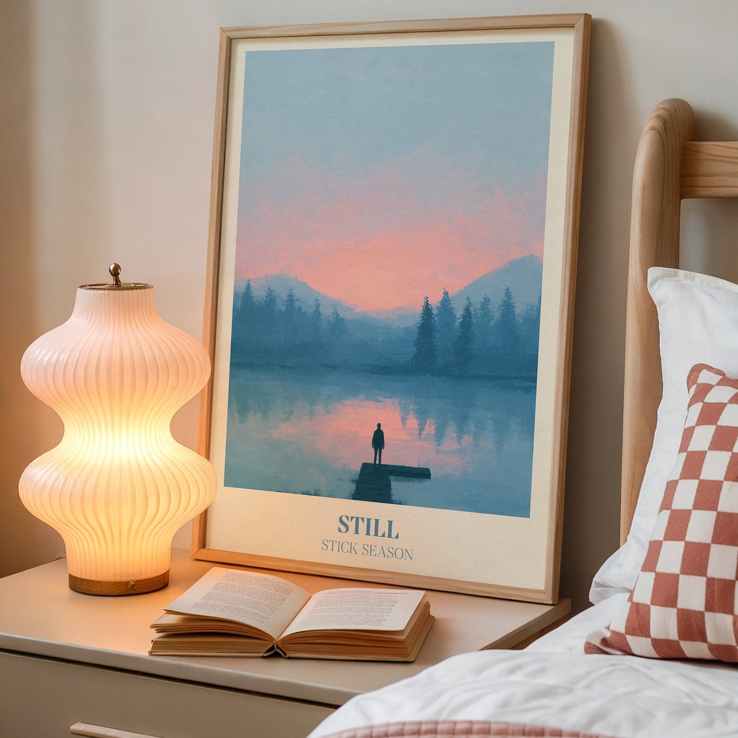 Still lyric wall art print inspired by Noah Kahan on a bedside table next to a lamp