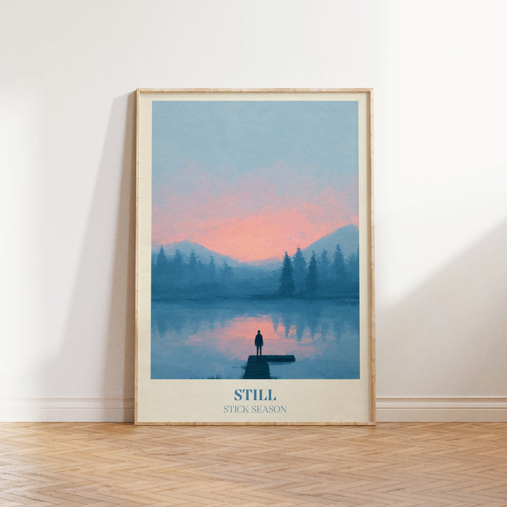 Still lyric wall art print inspired by Noah Kahan leaning against a white wall on a wooden herringbone floor in soft daylight