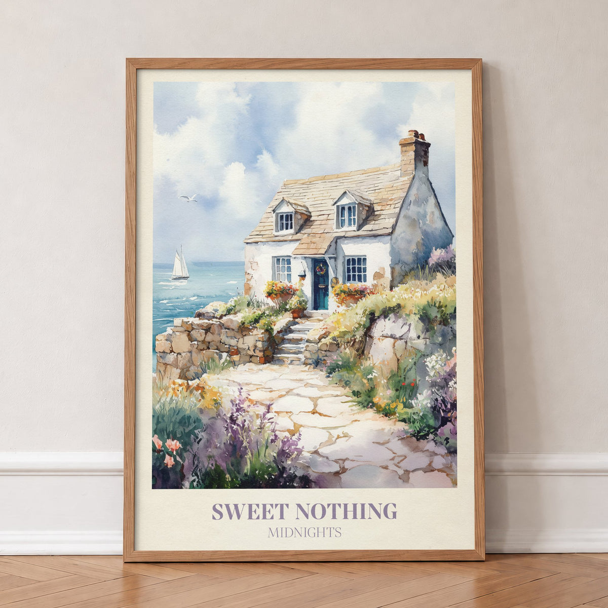 Sweet Nothing Taylor Swift print of a white seaside cottage with a stone path and wildflowers, in an oak frame, leaning against a wall on a herringbone floor