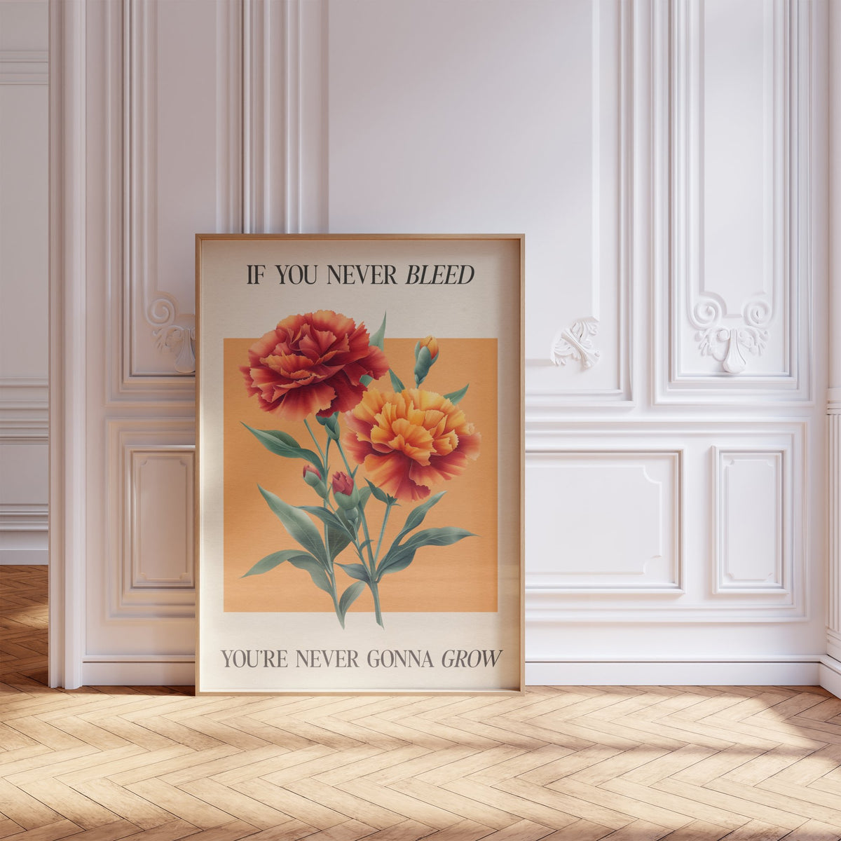 The 1 Botanical Taylor Swift print of red and orange carnations on a peach square, framed, leaning against a white panelled wall