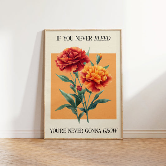 The 1 Botanical Taylor Swift print of red and orange carnations on a peach square, framed, leaning against a white wall