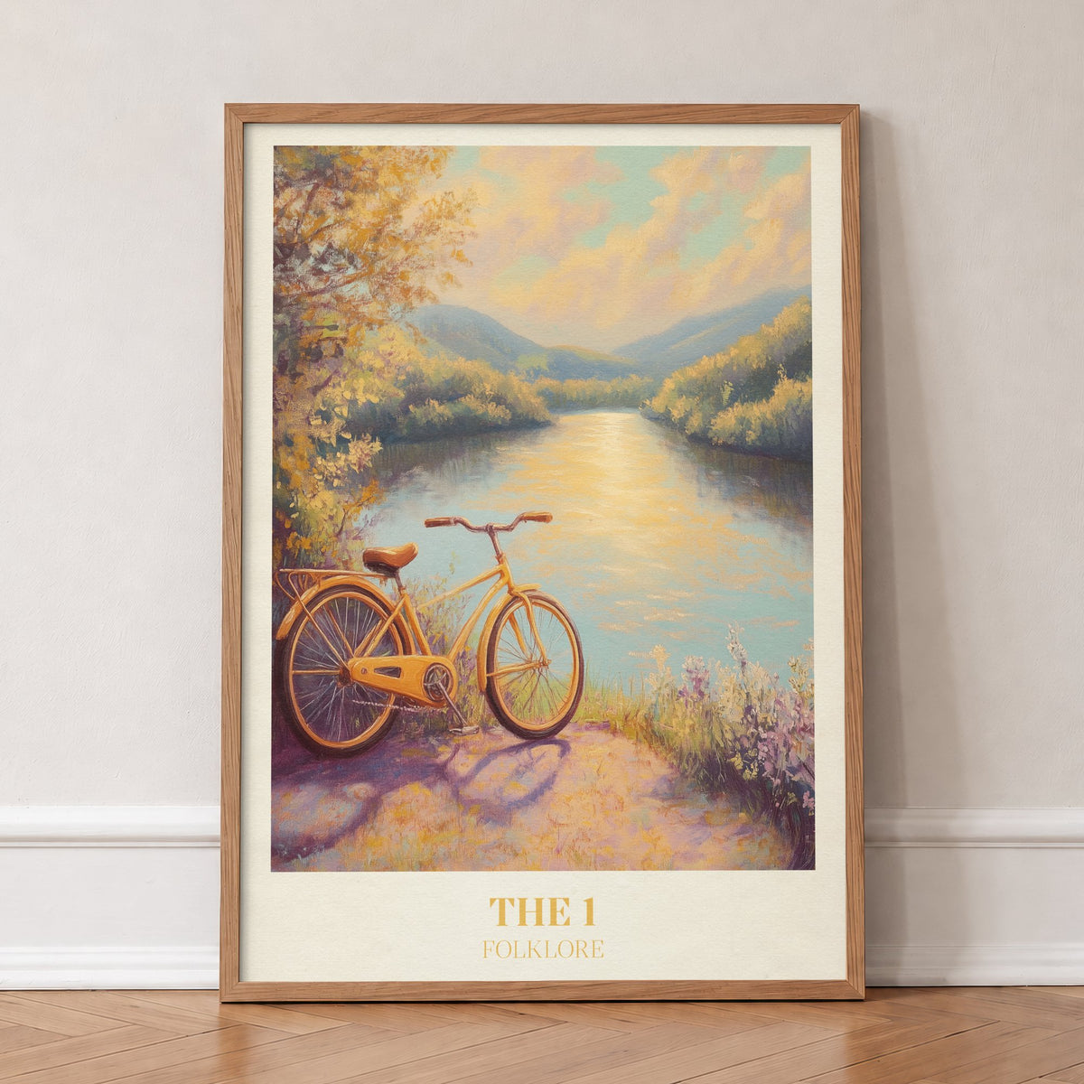 The 1 Taylor Swift print of a yellow bicycle beside a sunlit river, in an oak frame, leaning against a wall on a herringbone floor