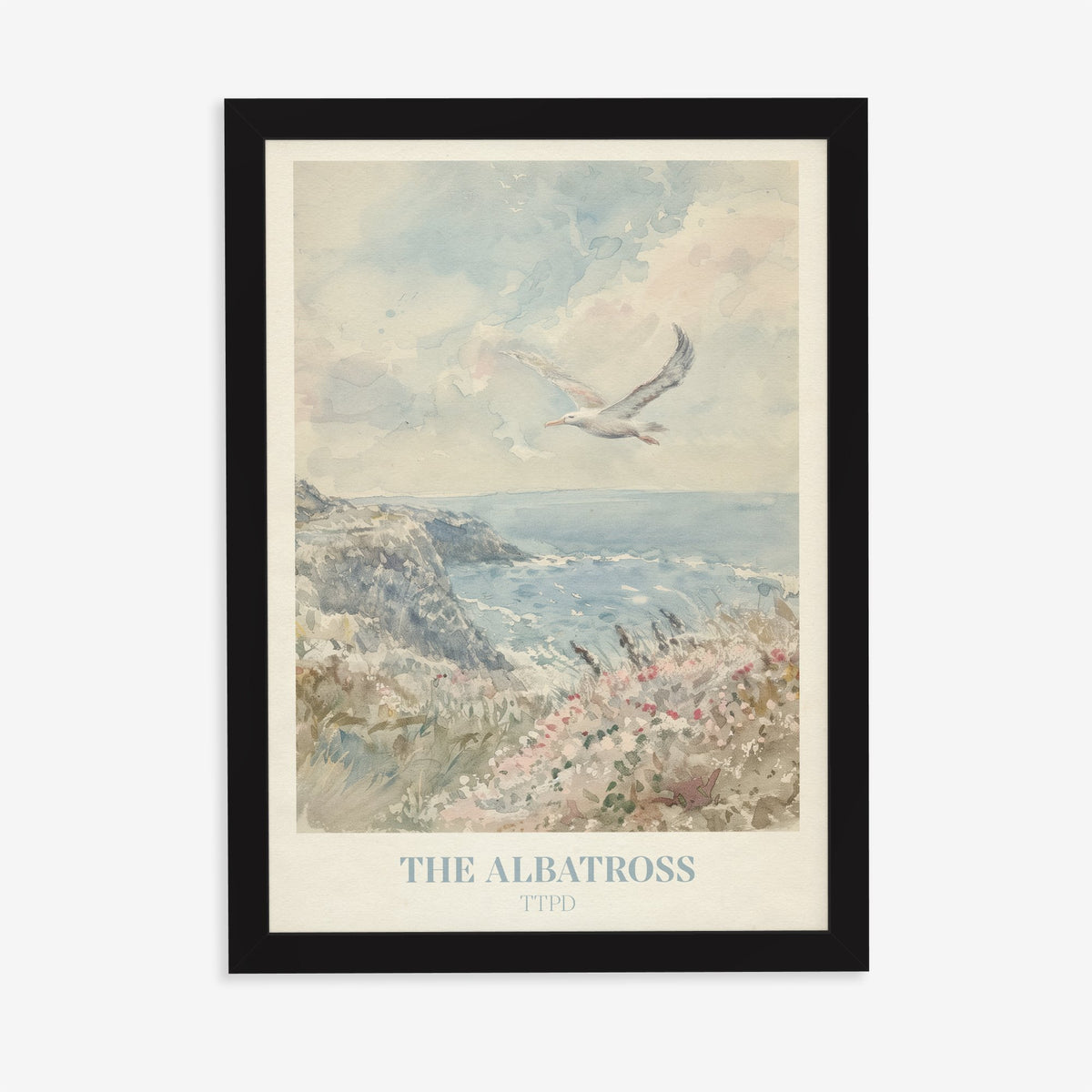 The Albatross Taylor Swift print of a seabird over a clifftop of pink wildflowers, in a black frame on a plain wall