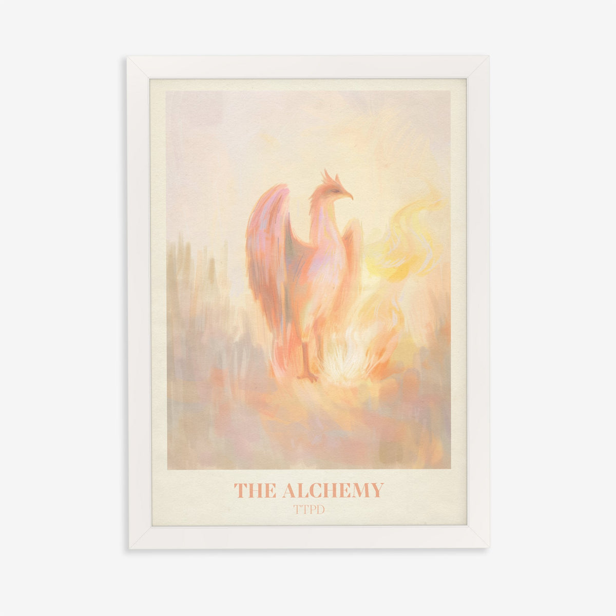 The Alchemy Taylor Swift print of a pink and peach phoenix rising beside golden flames, in a white frame on a plain wall