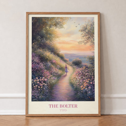 The Bolter Taylor Swift print of a woman walking a flowering path towards a sunset sea, in an oak frame, leaning against a wall on a herringbone floor