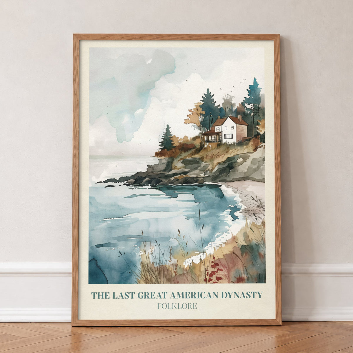 The Last Great American Dynasty Taylor Swift print of a white clifftop house above a cove, in an oak frame, leaning against a wall on a herringbone floor