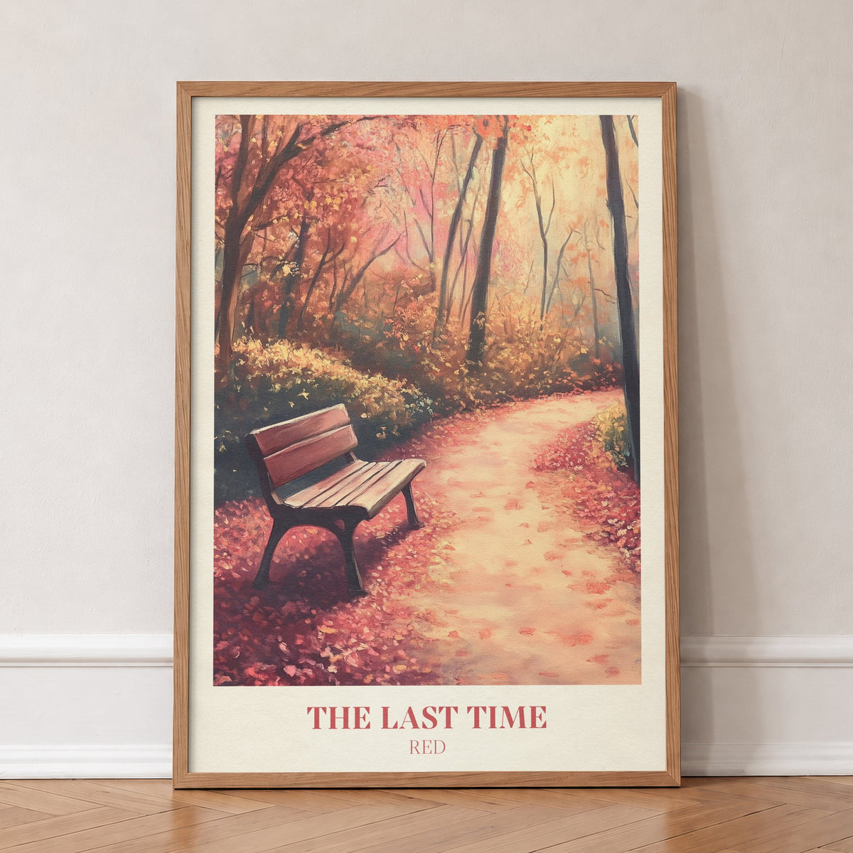 The Last Time Taylor Swift print of an empty bench on a path of red autumn leaves, in an oak frame, leaning against a wall on a herringbone floor