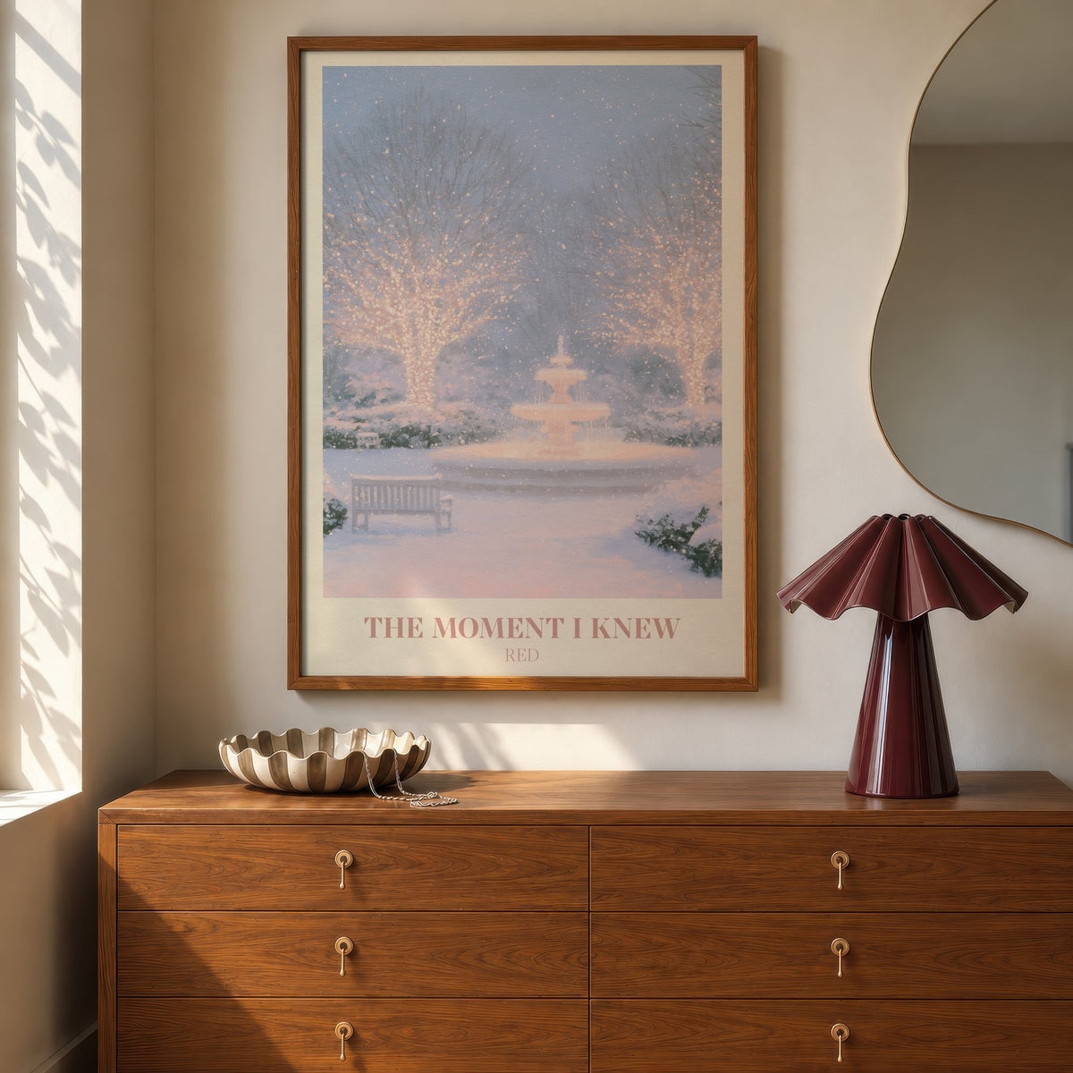 The Moment I Knew Taylor Swift print of a fairy-lit snowy park, hung above a walnut dresser beside a wavy mirror and a pleated lamp
