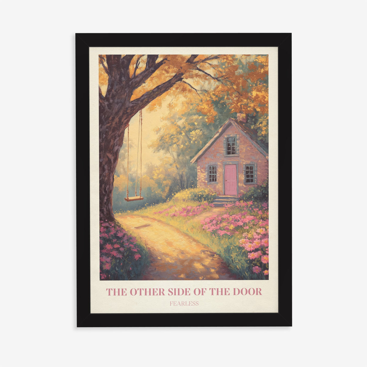 The Other Side Of The Door Taylor Swift print of a brick cottage with a pink door and a tree swing, in a black frame on a plain wall