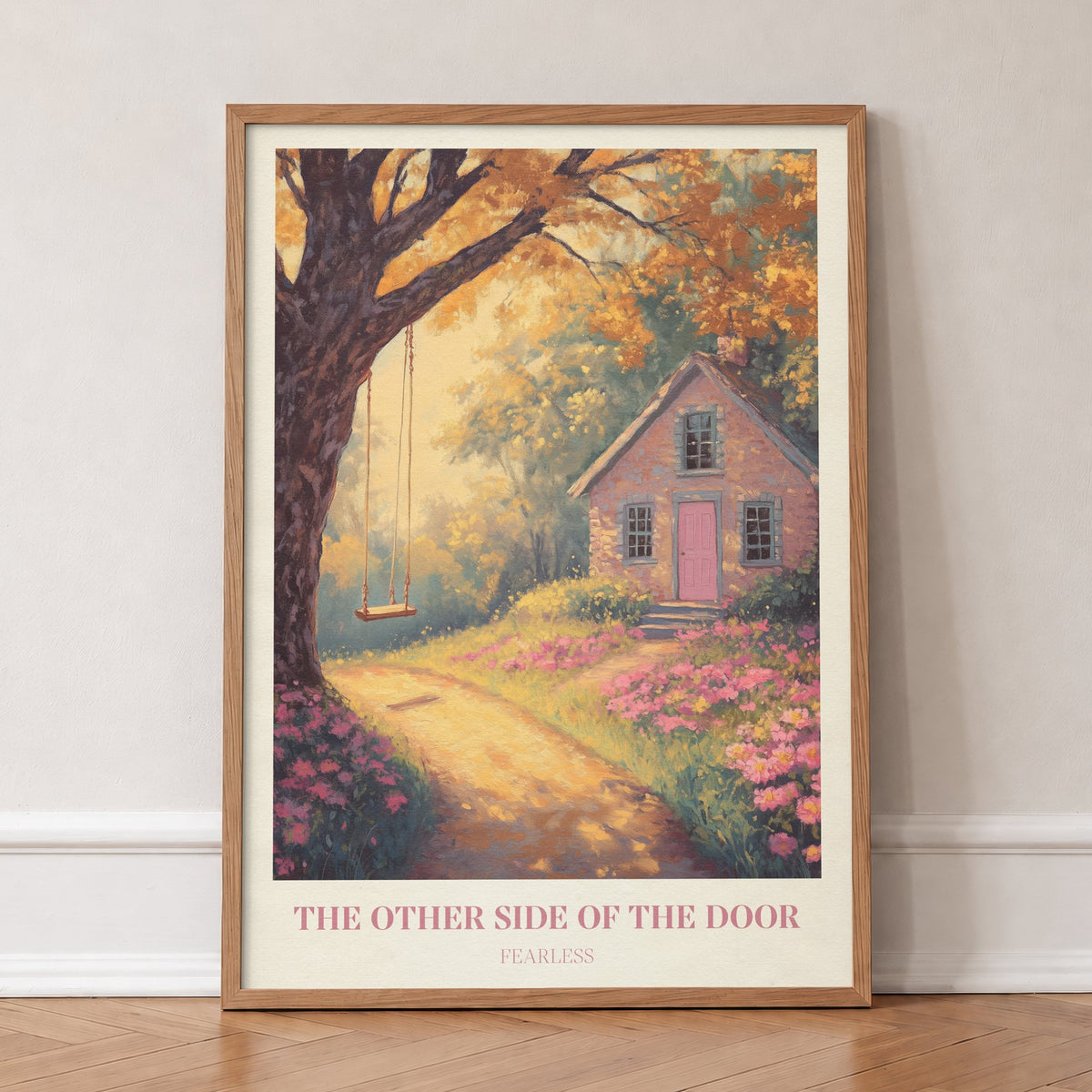 The Other Side Of The Door Taylor Swift print of a brick cottage with a pink door and a tree swing, in an oak frame, leaning against a wall on a herringbone floor