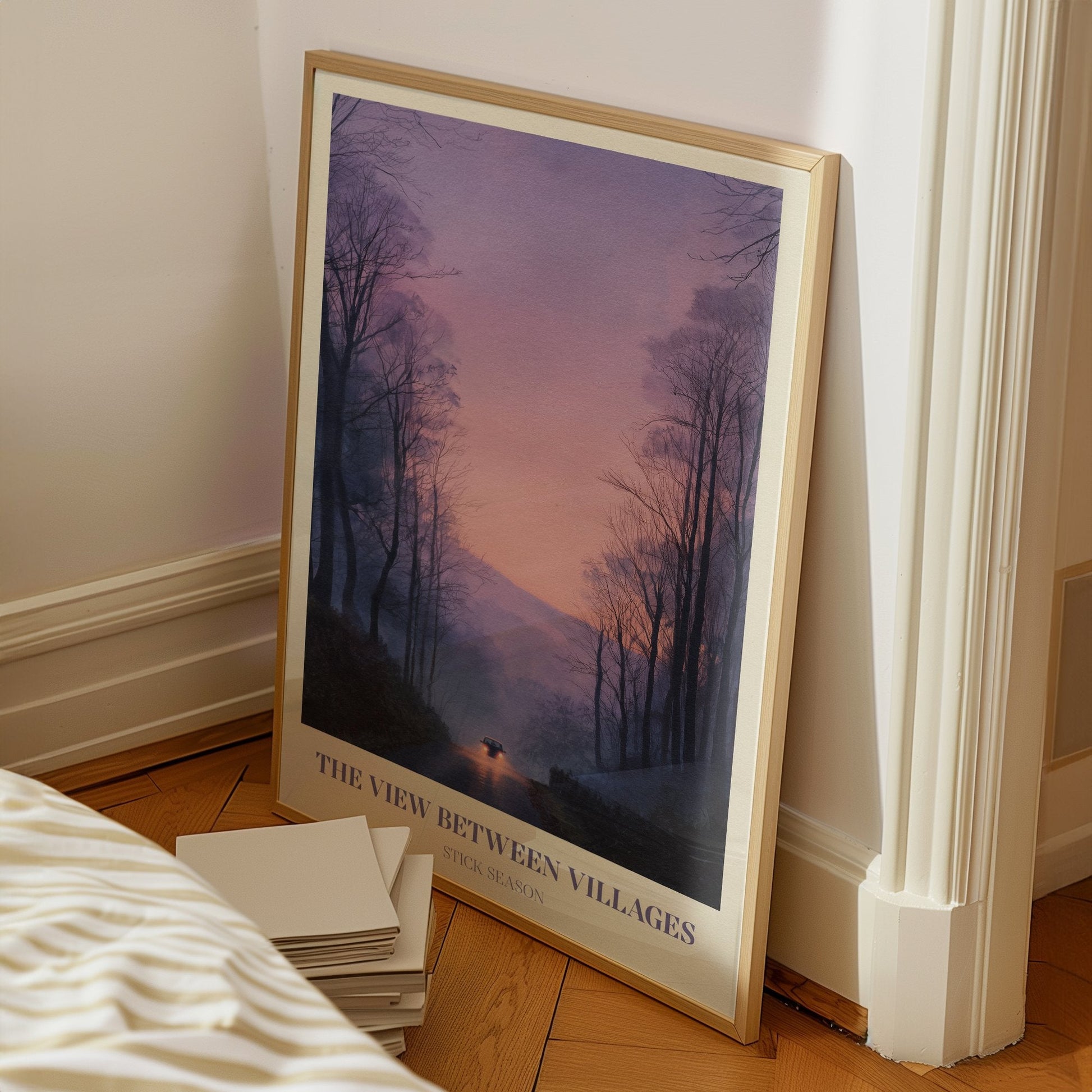 The View Between Villages lyric wall art print inspired by Noah Kahan on a bedroom floor, leaning against a white wall