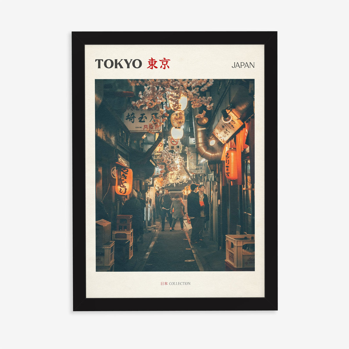 Tokyo travel print of a narrow side street at night lit by red paper lanterns, in a black frame on a plain wall