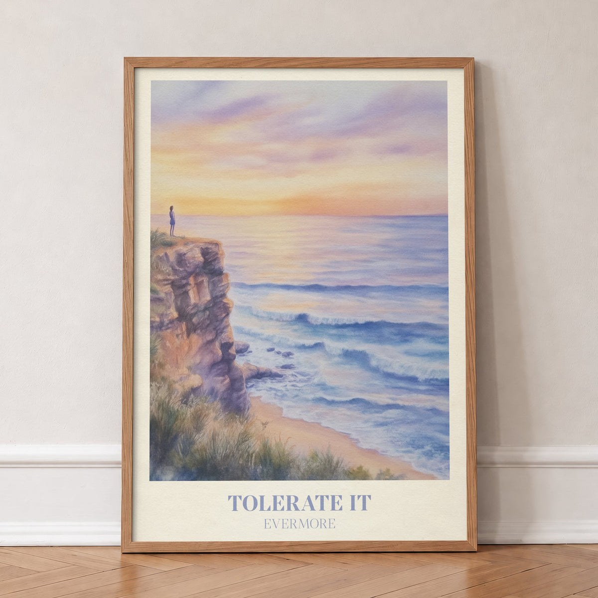 Tolerate It Taylor Swift print of a lone figure on a clifftop above a lilac sunset sea, in an oak frame, leaning against a wall on a herringbone floor