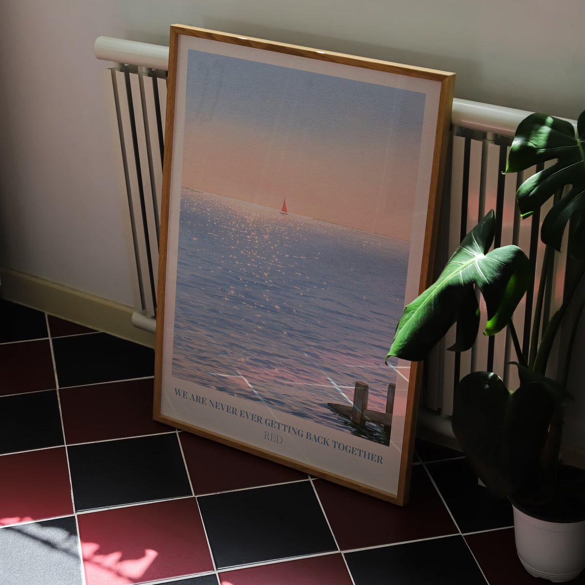 We Are Never Ever Getting Back Together Taylor Swift print of a red sailboat, on a kitchen floor with red and black tiles