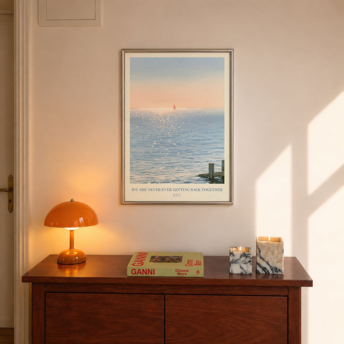 We Are Never Ever Getting Back Together Taylor Swift print of a red sailboat, hung above a hall console beside an orange lamp