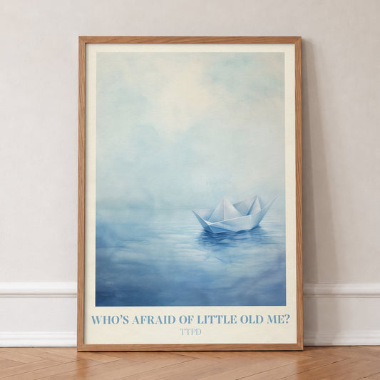 Who’s Afraid Of Little Old Me? Taylor Swift print of a paper boat on calm, misty blue water, in an oak frame, leaning against a wall on a herringbone floor