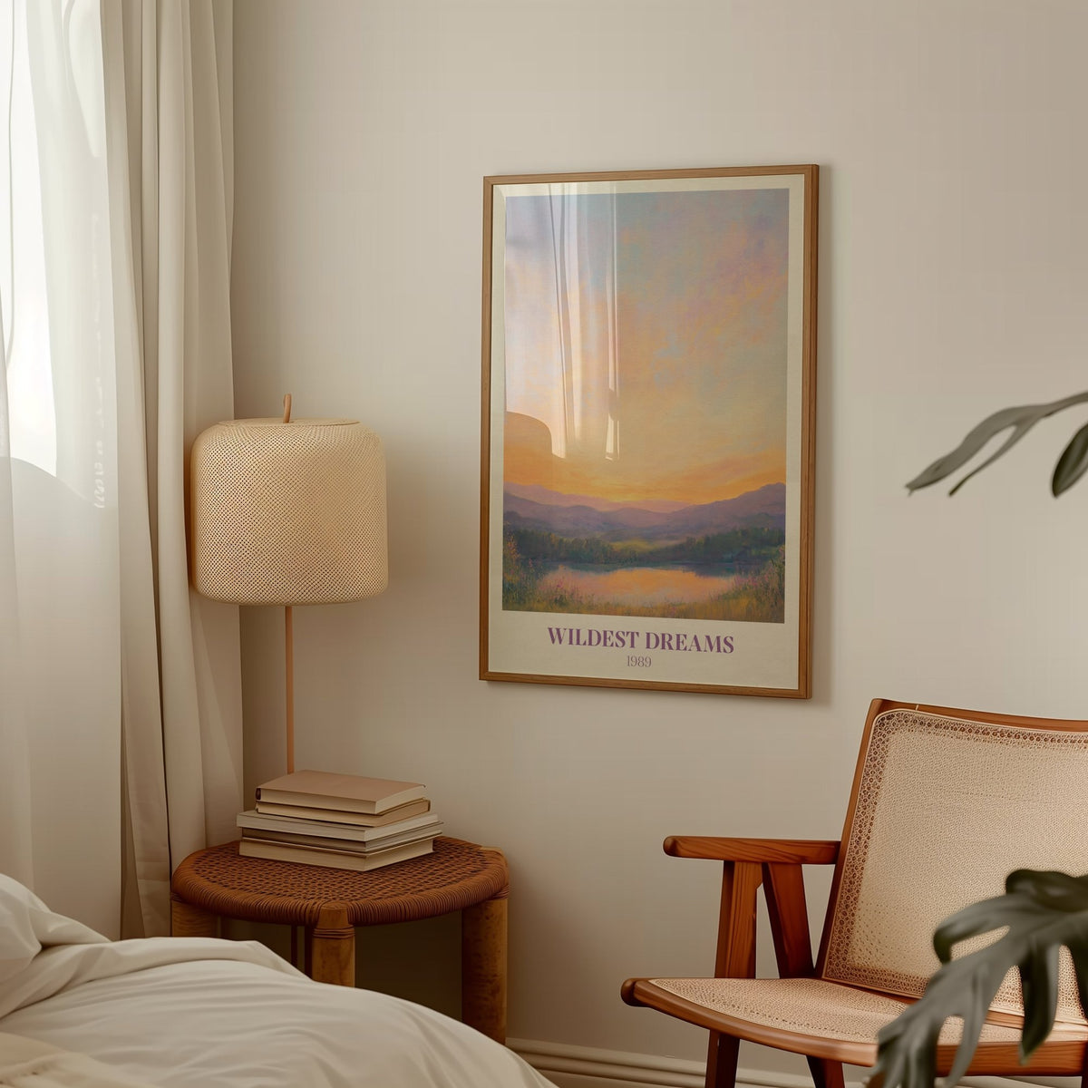 Wildest Dreams Taylor Swift print of a painted peach and lilac sunset over hills and a lake, framed above a side table and lamp