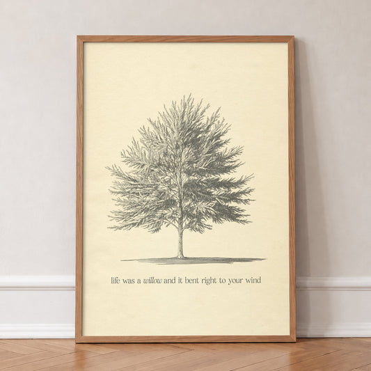 Willow Minimal Taylor Swift print of a pencil-sketched tree above a line from the song, in an oak frame, leaning against a wall on a herringbone floor