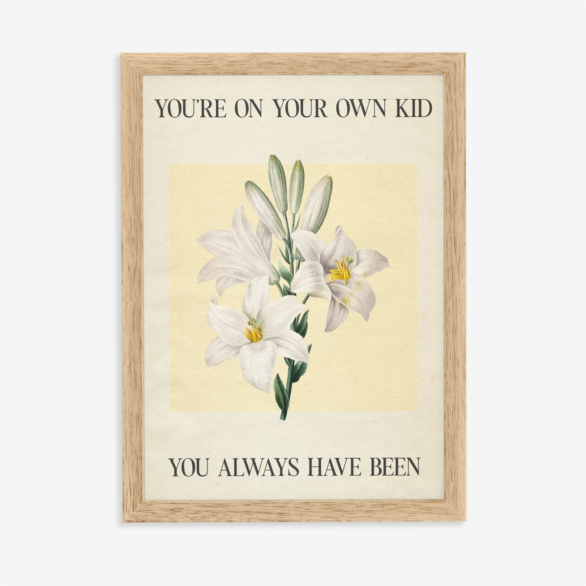 You’re On Your Own Kid Botanical Taylor Swift lyric print of white lilies on yellow, in an oak frame on a plain wall