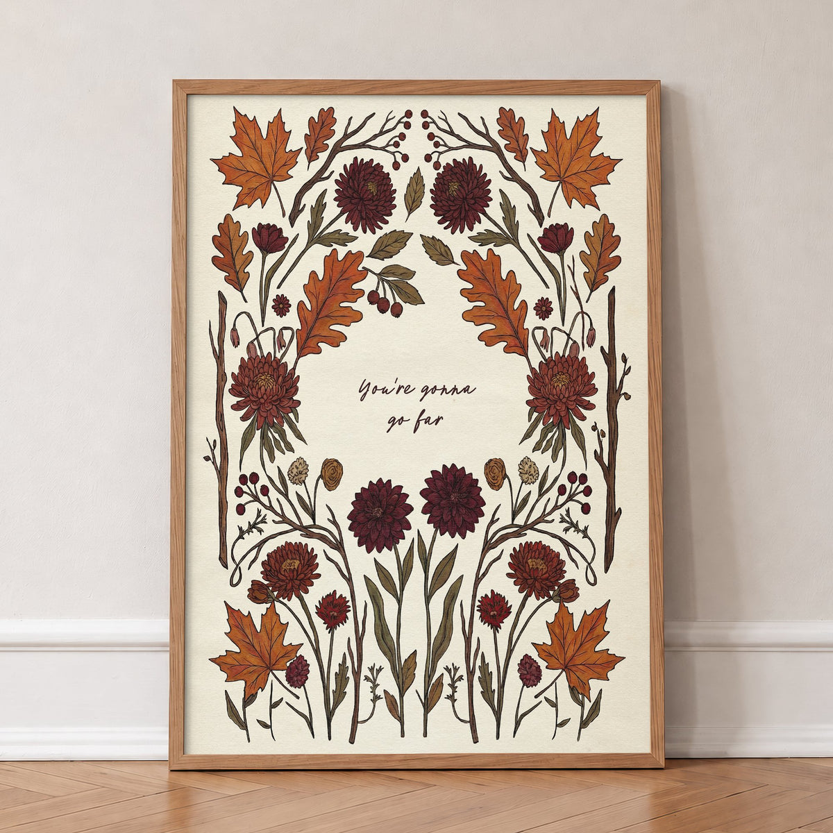 You're Gonna Go Far Noah Kahan lyric print with a border of autumn leaves and dahlias, in an oak frame, leaning against a wall on a herringbone floor