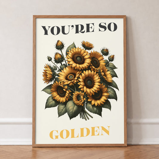 You're So Golden Harry Styles print of a sunflower bouquet on cream, in an oak frame, leaning against a wall on a herringbone floor